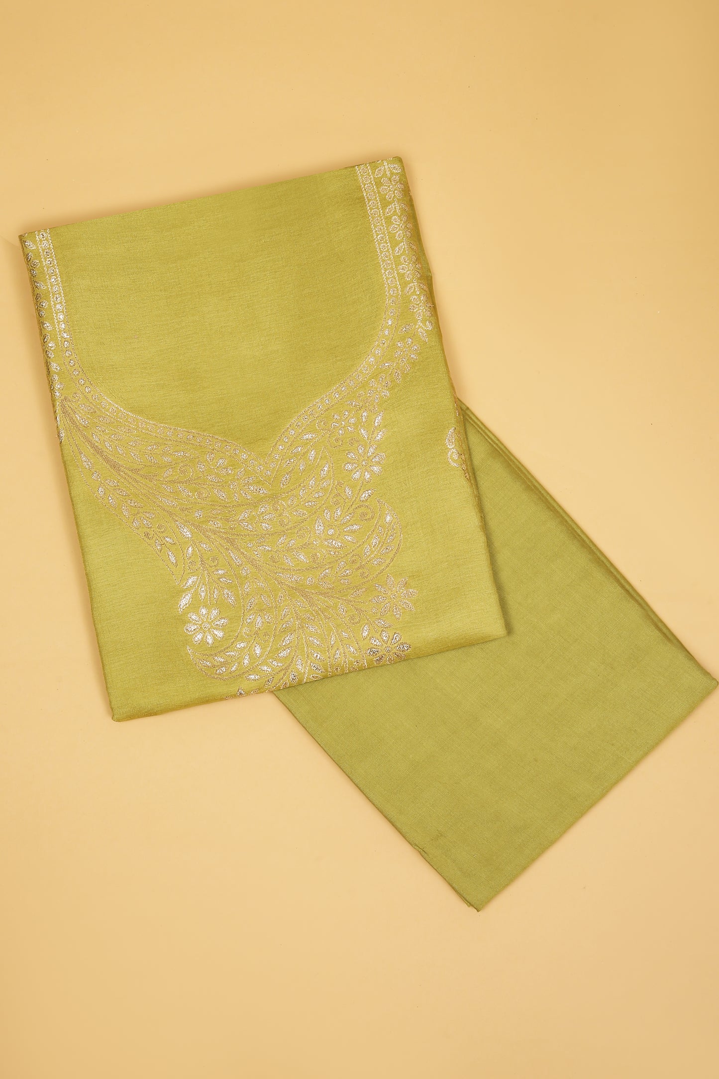 Green Chanderi Silk suit in Neck Design and tradtional motifs on body woven with golden zari and Ombre motif weaved Dupatta giving subtle contrast with shirt