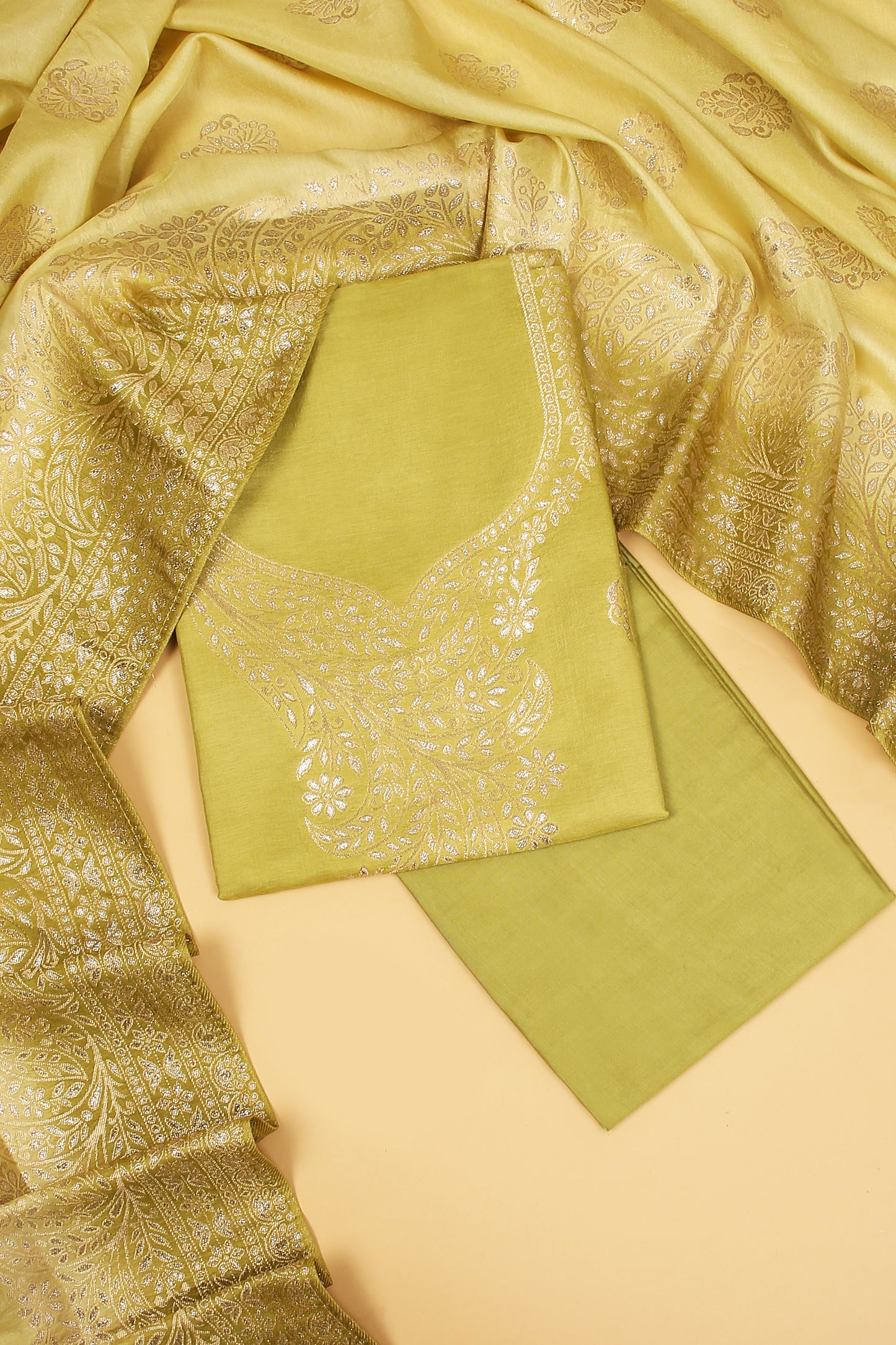 Green Chanderi Silk suit in Neck Design and tradtional motifs on body woven with golden zari and Ombre motif weaved Dupatta giving subtle contrast with shirt