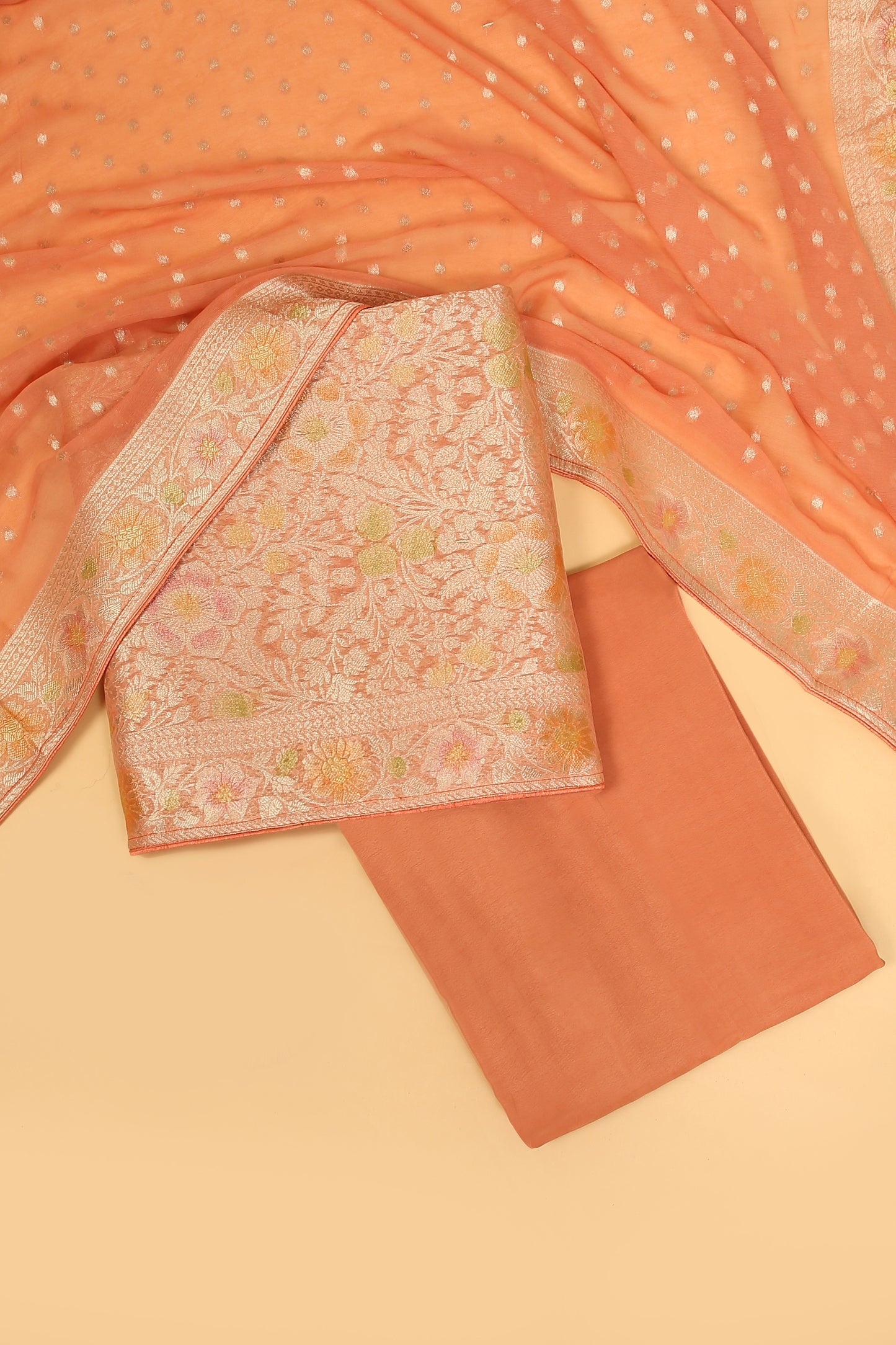 Peach Khaddi Georgette Silk Suit in Floral Jaal pattern on shirt and Rangkaat on shirt and dupatta with plain crepe silk bottom