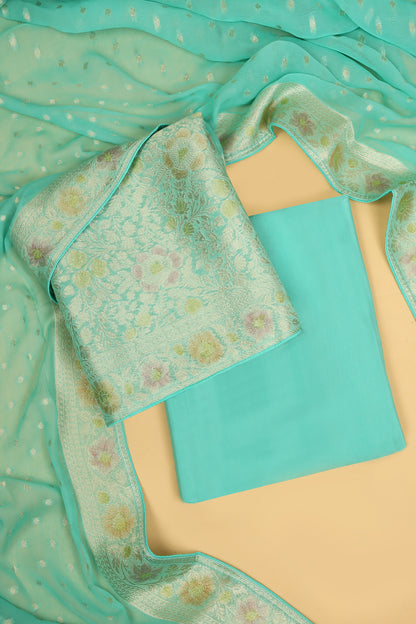 Turquoise Khaddi Georgette Silk Suit in Floral Jaal pattern on shirt and Rangkaat on shirt and dupatta with plain crepe silk bottom