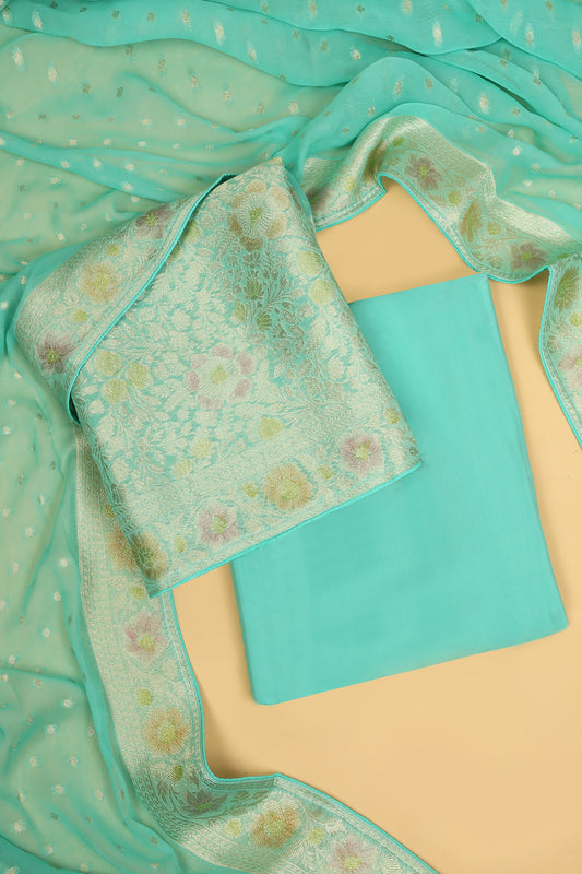 Turquoise Khaddi Georgette Silk Suit in Floral Jaal pattern on shirt and Rangkaat on shirt and dupatta with plain crepe silk bottom