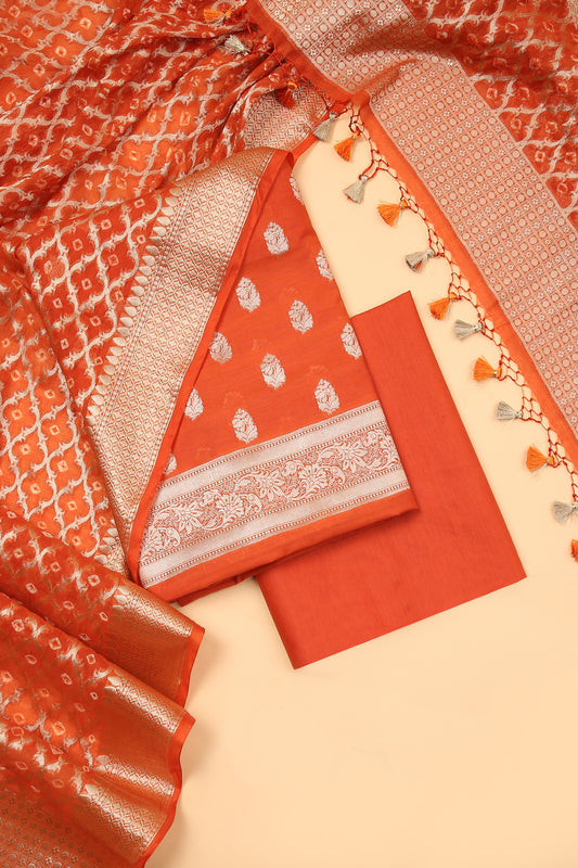 Orange Banarasi Chanderi Silk unstitched suit set in Zari Buti woven shirt with Bandhani and woven dupatta