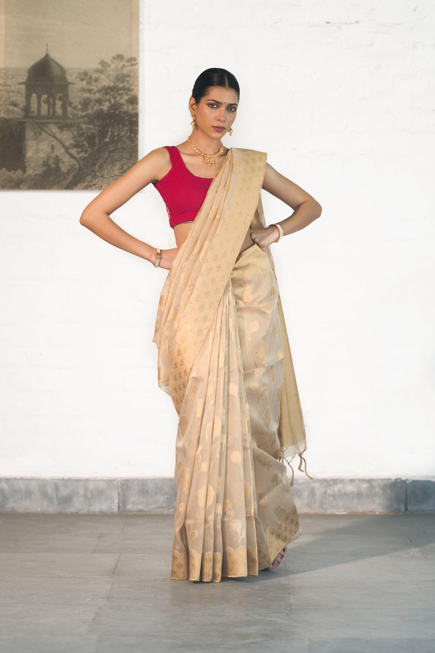 Golden Tissue Saree woven in Floral Motifs paired with scallop style border and rich palla