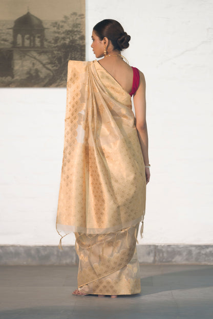 Golden Tissue Saree woven in Floral Motifs paired with scallop style border and rich palla