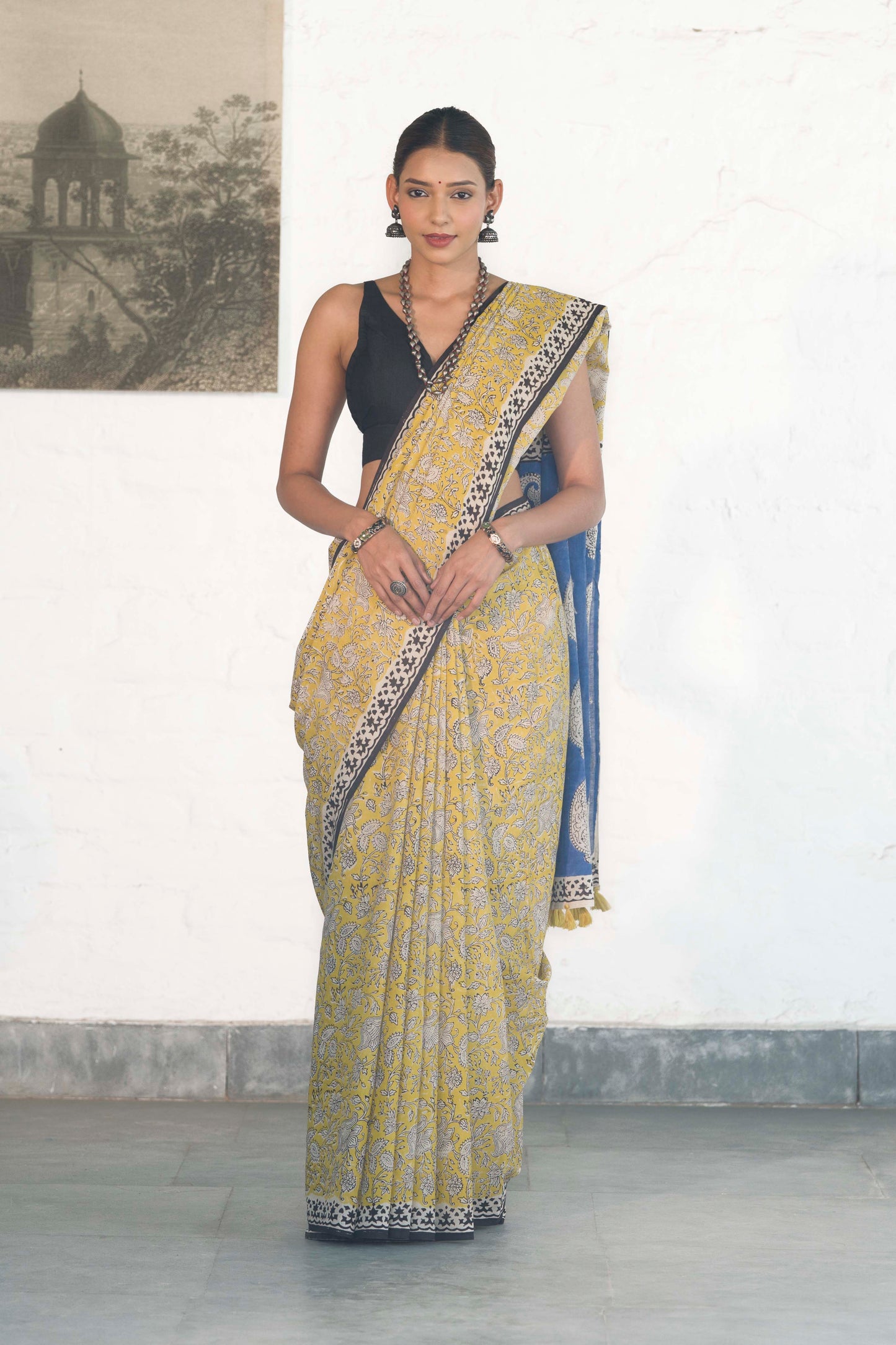 Yellow Mul Cotton Saree with Kalamkari handblock print and contrast handblock palla accesorised with tassels