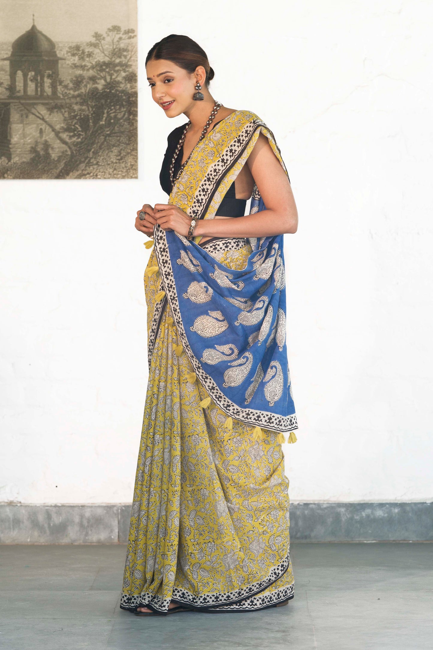 Yellow Mul Cotton Saree with Kalamkari handblock print and contrast handblock palla accesorised with tassels