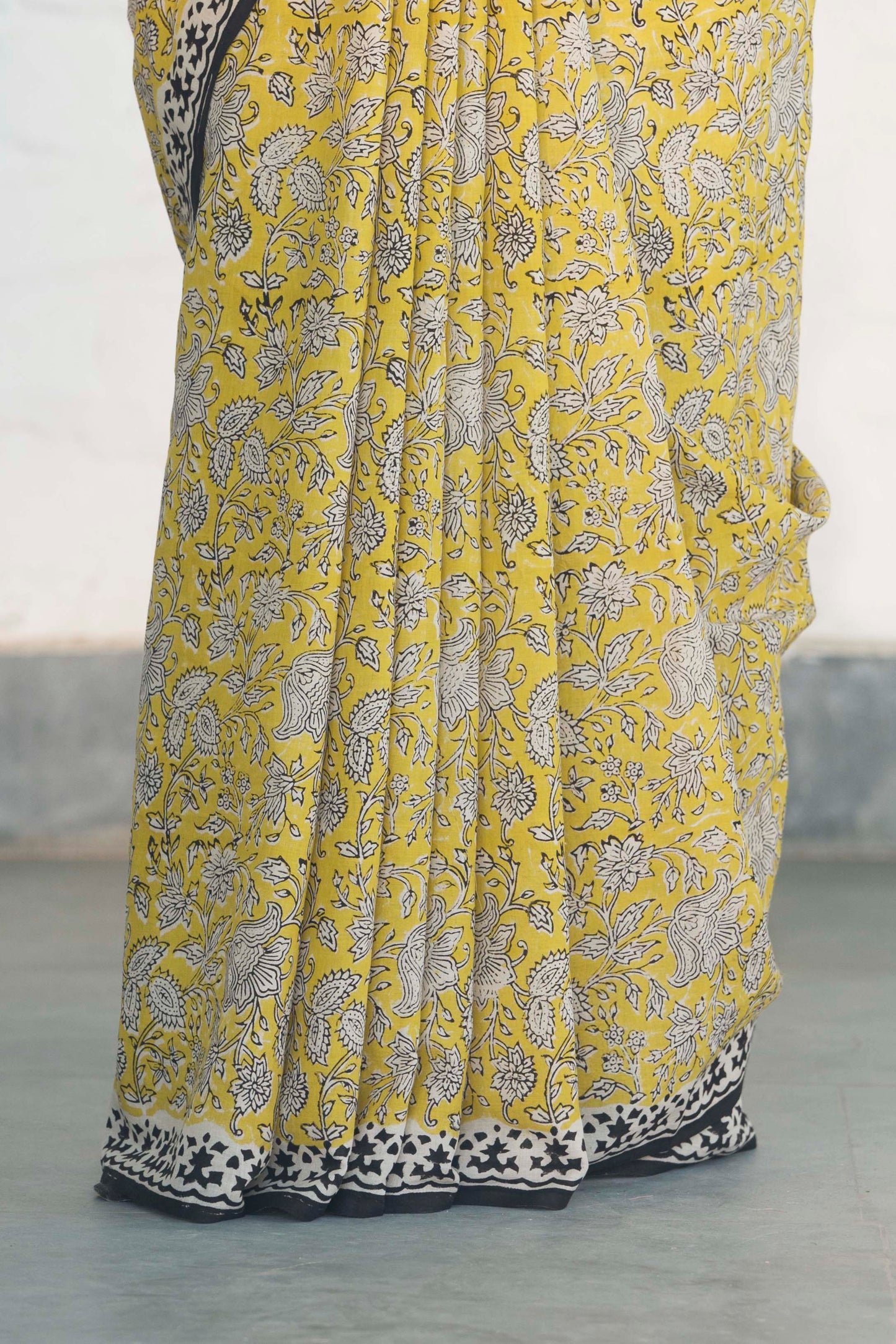 Yellow Mul Cotton Saree with Kalamkari handblock print and contrast handblock palla accesorised with tassels