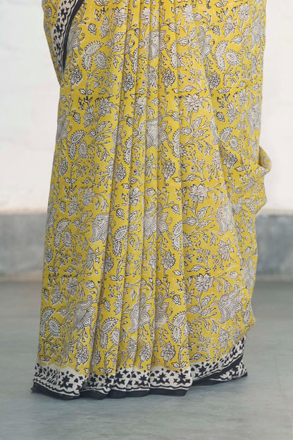 Yellow Mul Cotton Saree with Kalamkari handblock print and contrast handblock palla accesorised with tassels