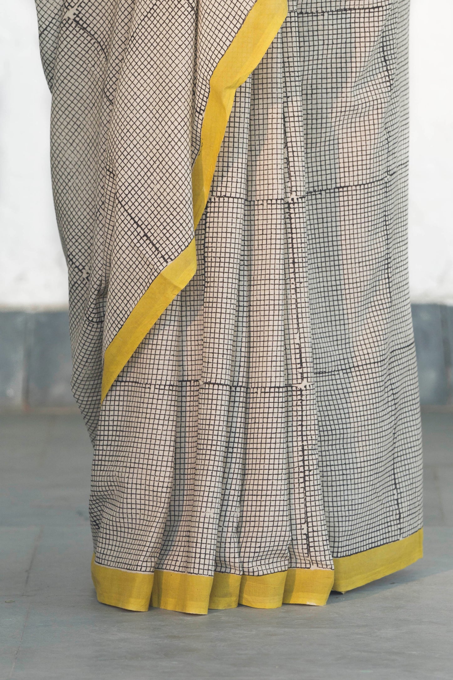 Off White Mul Cotton Saree with small checks handblock print and striped design palla accesorised with tassels