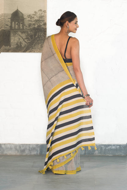 Off White Mul Cotton Saree with small checks handblock print and striped design palla accesorised with tassels