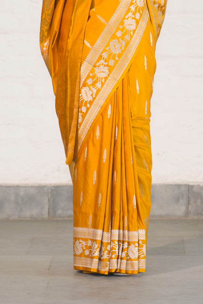 Yellow Mashru Silk Saree woven in Leaf inspired butis across body paired with Floral bel border